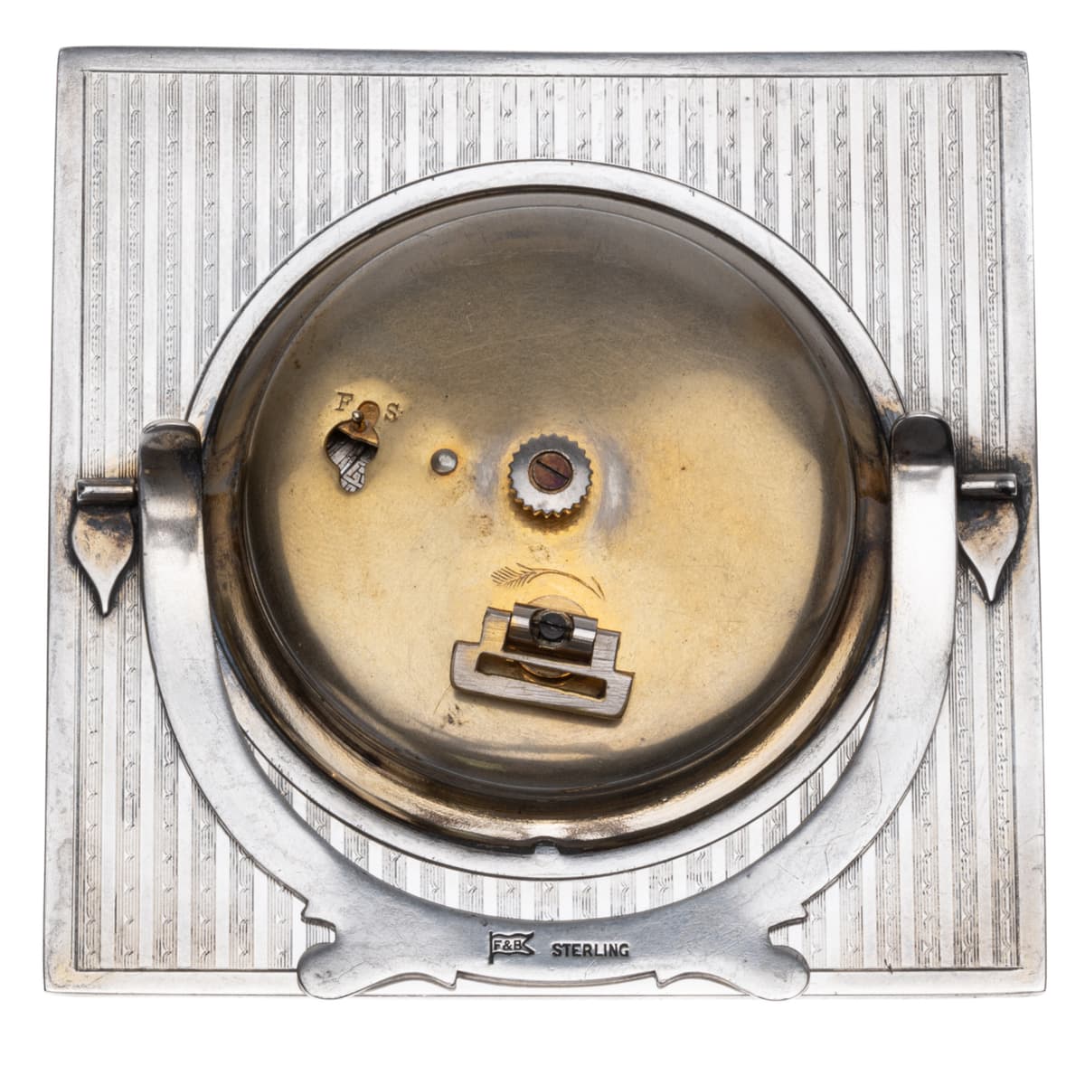 Back of Foster & Bailey sterling silver 8-day Swiss desk clock showing movement and folding stand.